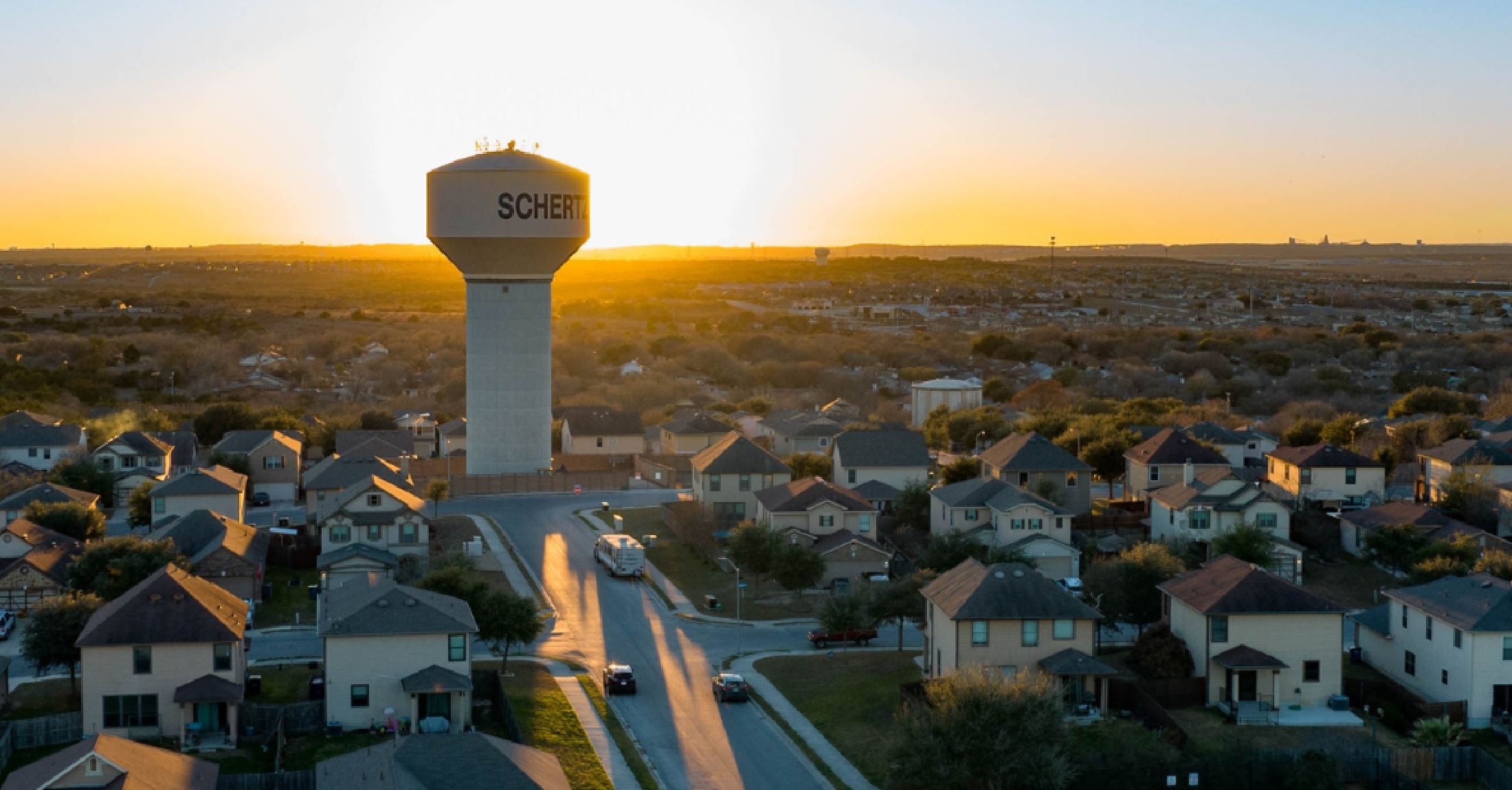 Established suburban homes on a tree-lined street in Schertz, TX
