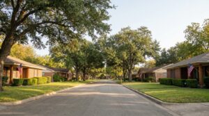 Tree-lined residential street with brick ranch homes in Universal City, TX